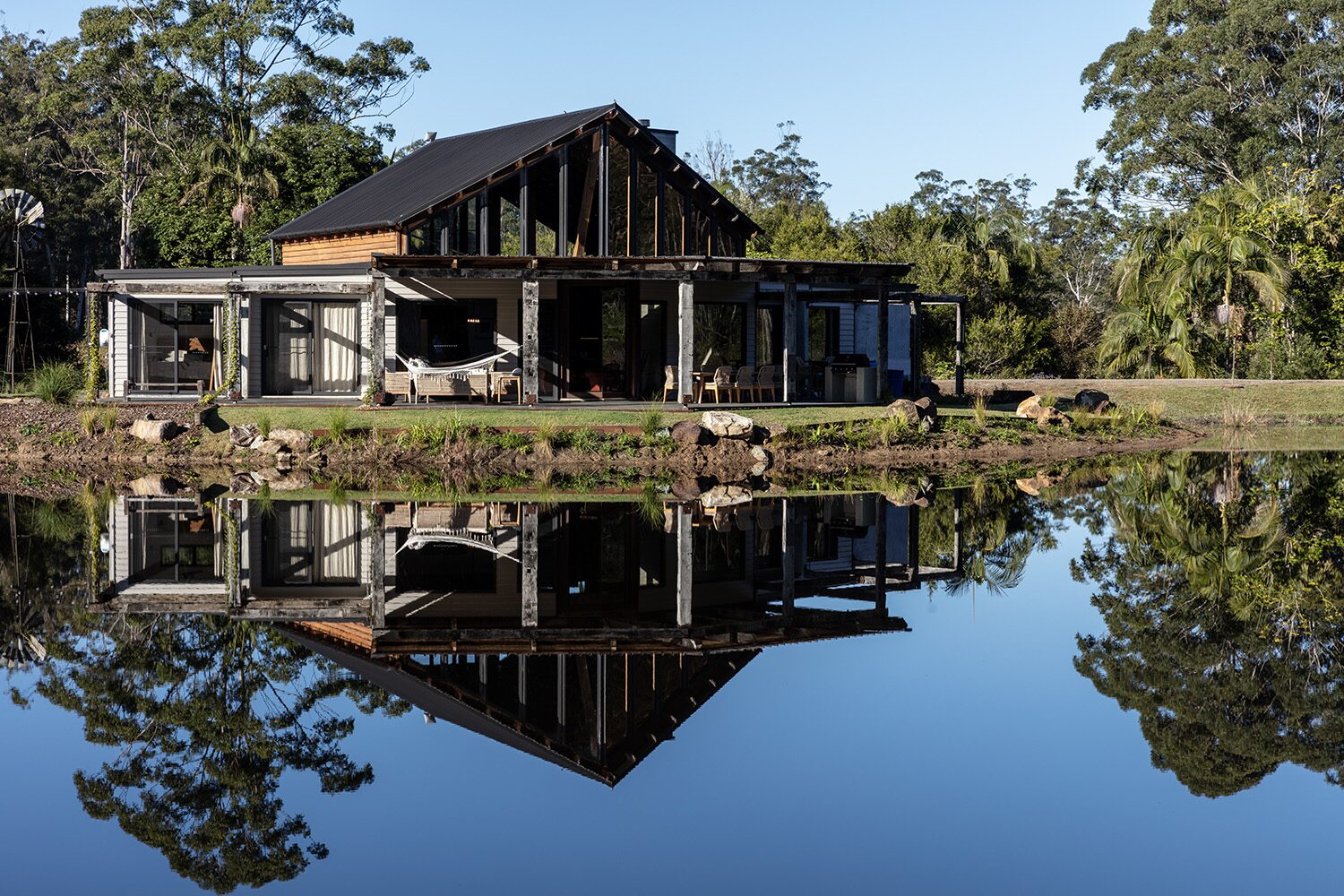 Arrowwood Acres — house and dam reflection by day