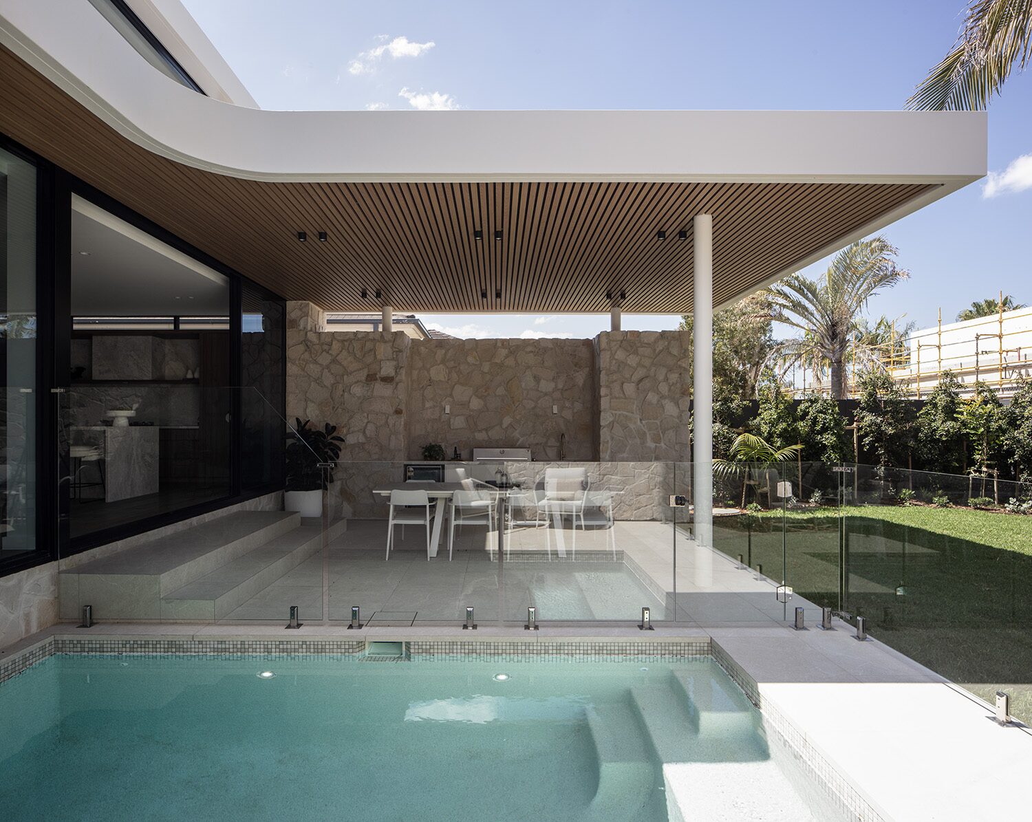 Binaville — pool terrace, stone-clad alfresco kitchen