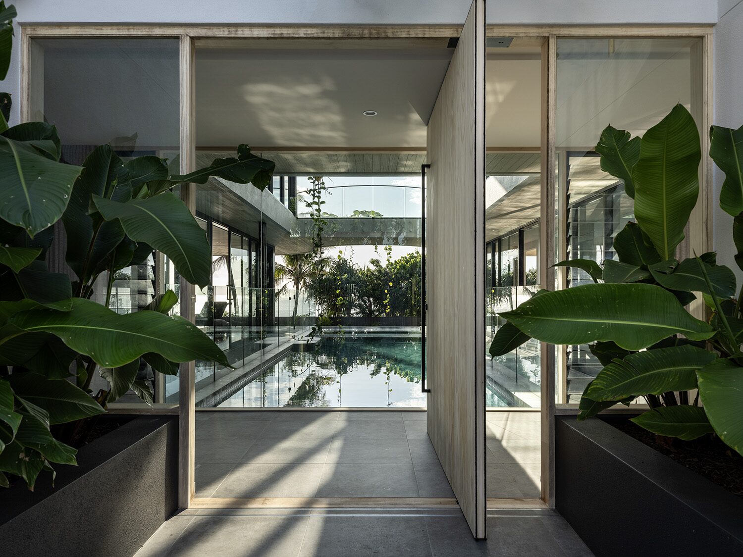 Netherby Rise — entry, pivot door opening to the pool
