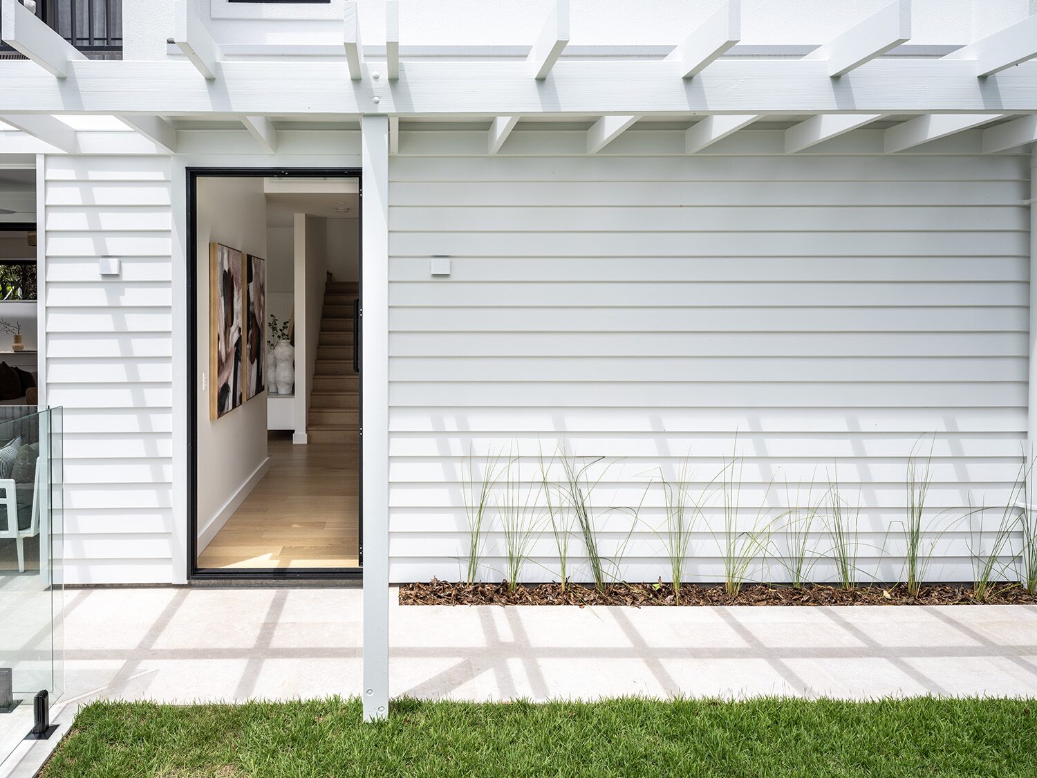Noosaville — courtyard entry, pergola and stairwell beyond
