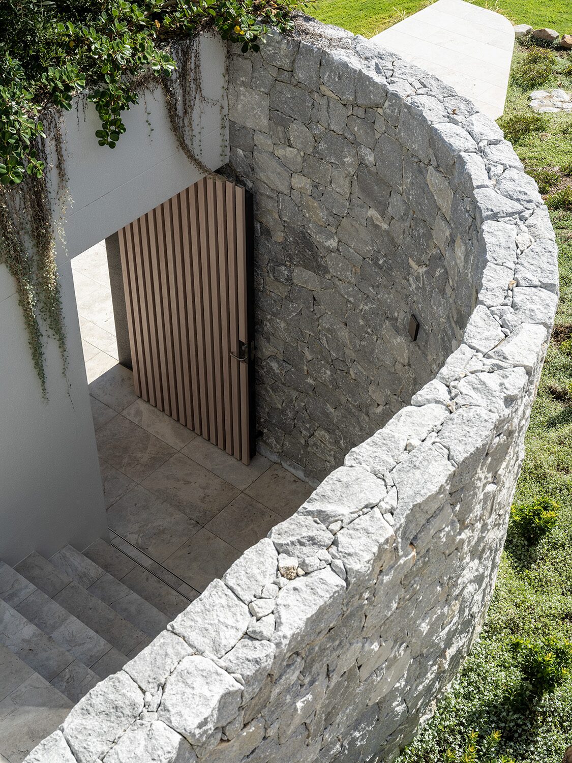 Pacific Heights — curved stone entry, timber-slat door