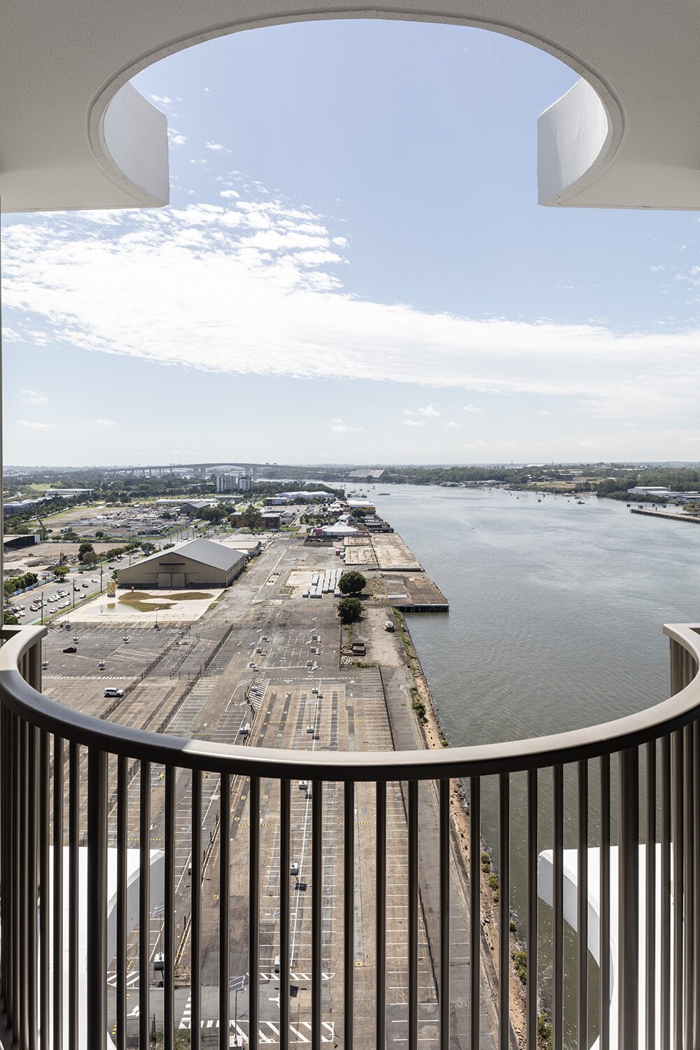Rivello Residences — balcony, round cutout framing the river