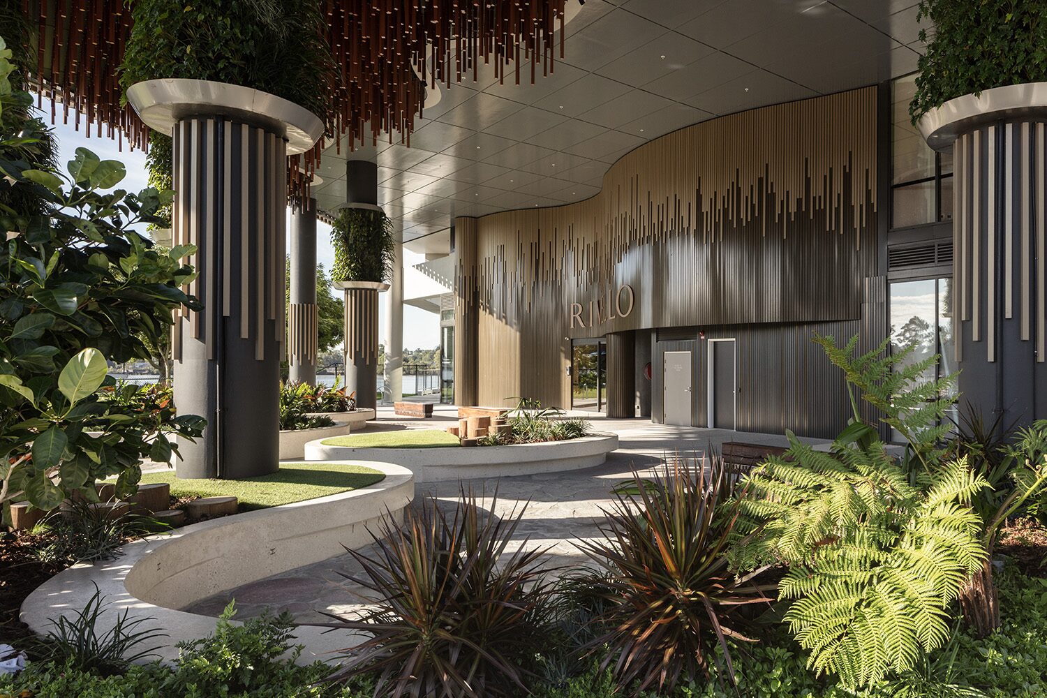 Rivello Residences — entrance porte-cochère beneath the timber batten facade