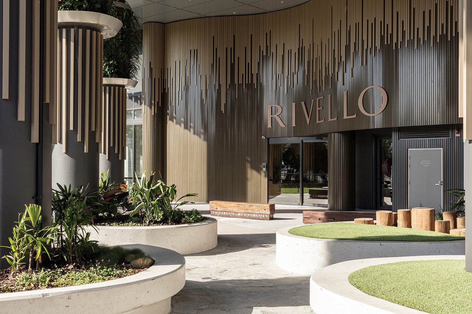 Rivello Residences — entrance signage, concrete planters detail