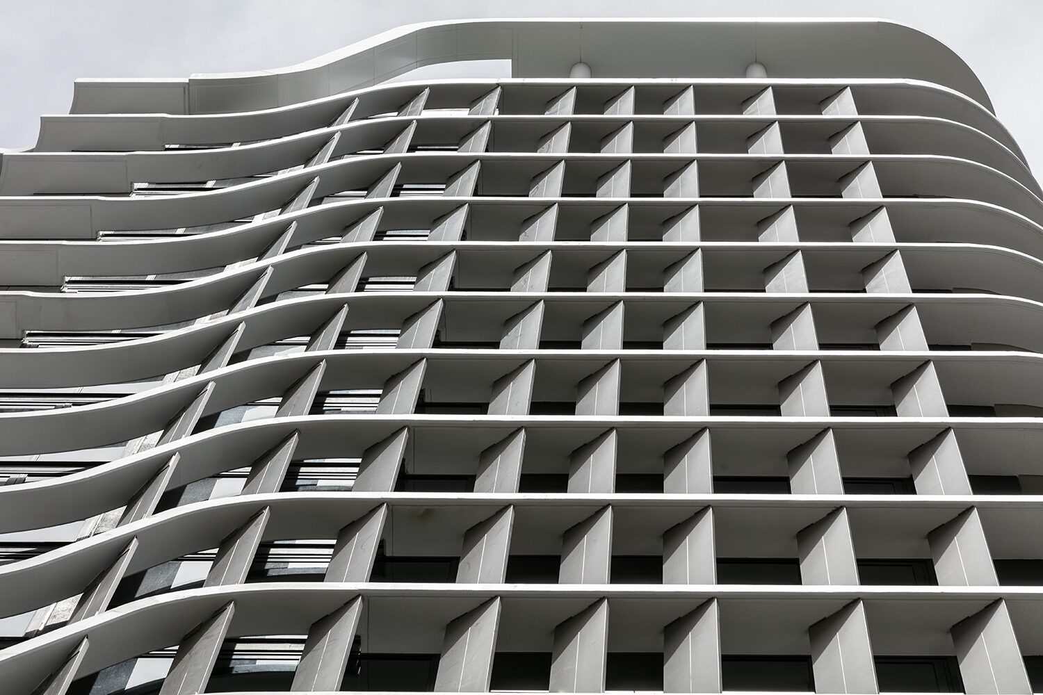 Rivello Residences — facade, sculptural fin and balcony grid