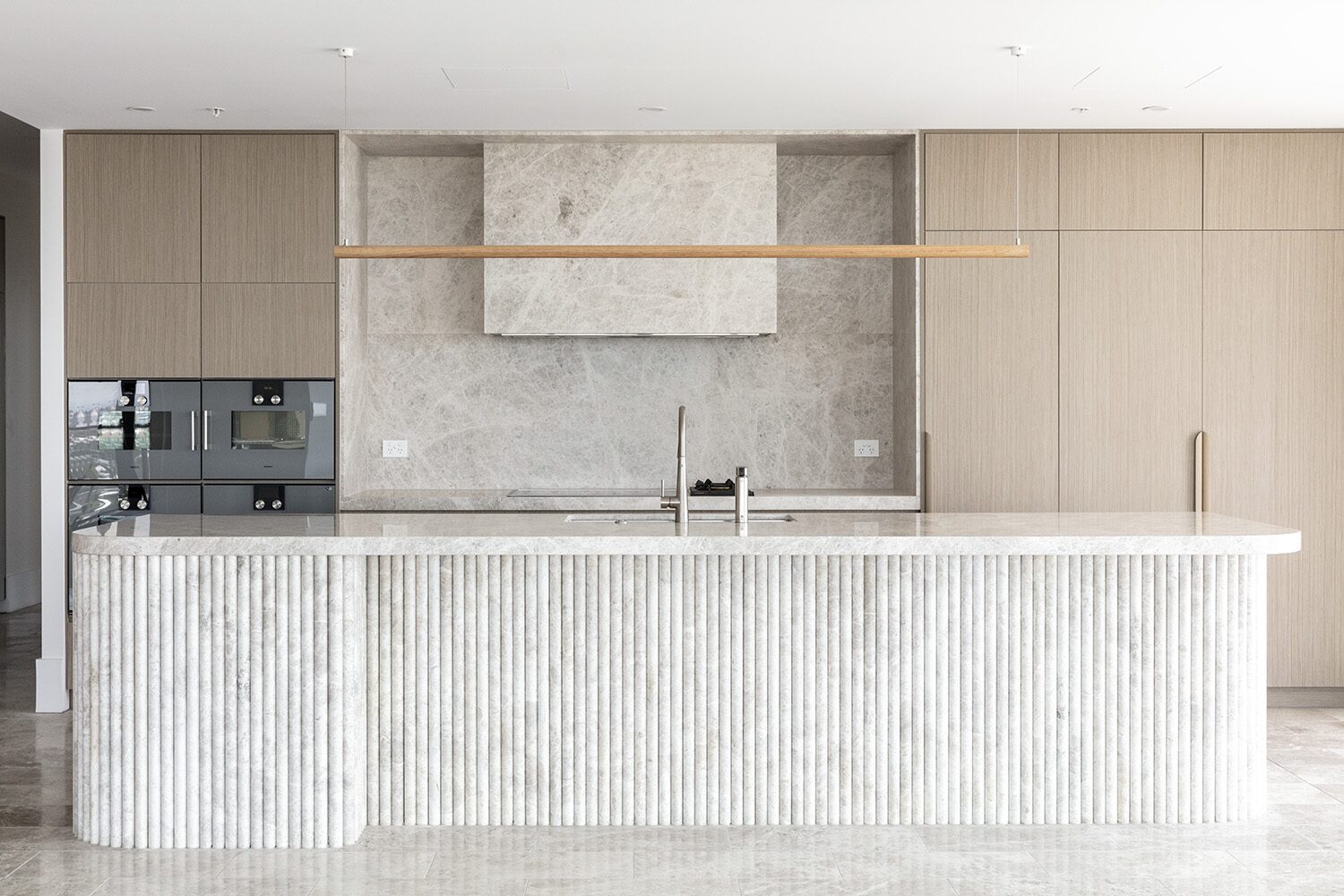 Rivello Residences — kitchen, fluted stone island