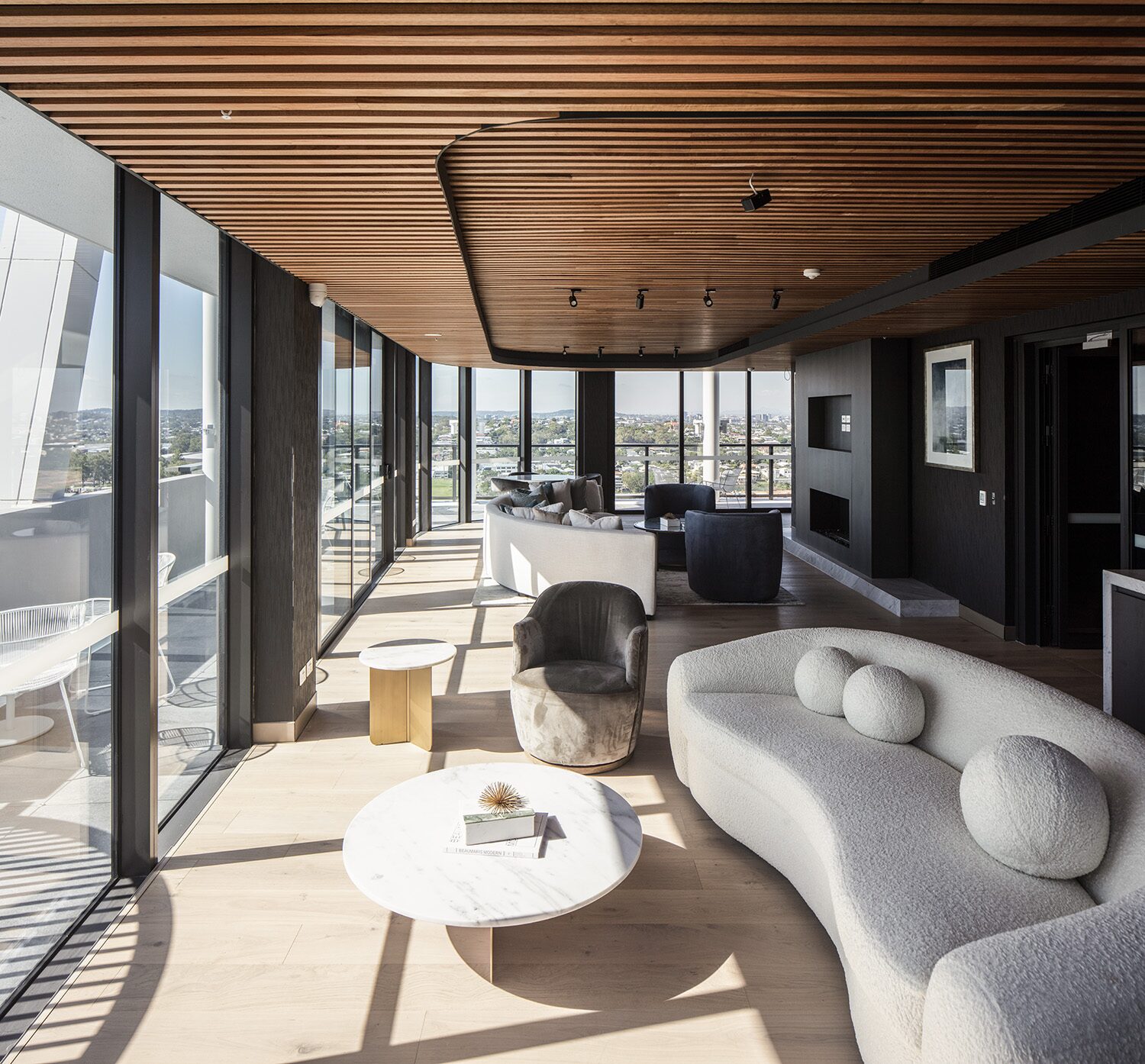 Rivello Residences — resident lounge, curved sofa and city view