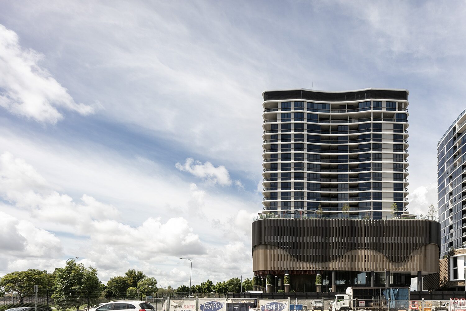 Rivello Residences — street-level view under a dramatic sky